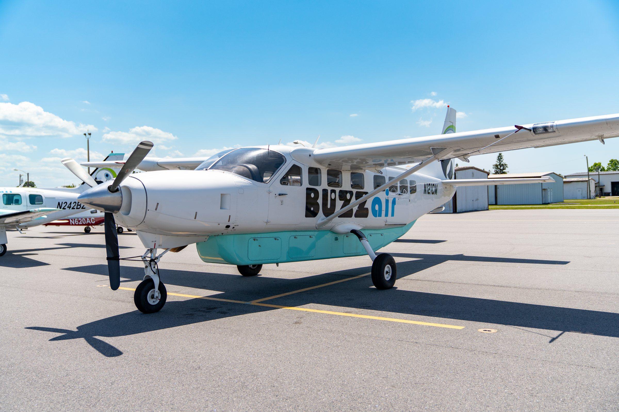 Buzz Air's Grand Caravan on the ramp with the passenger door open